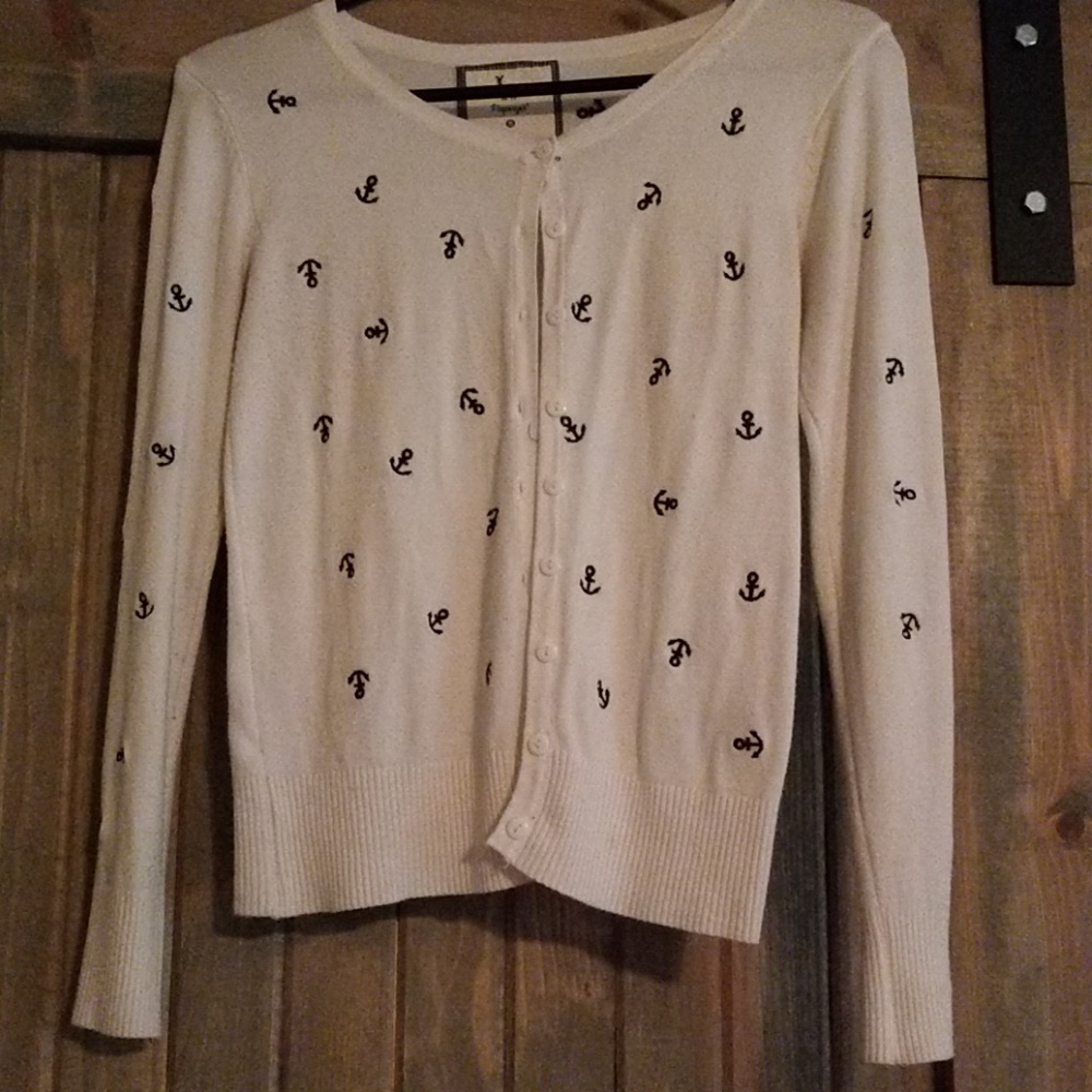 Blue anchors on light white button down sweater